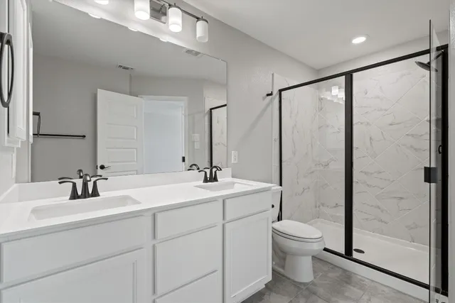 a bathroom with double sink and a mirror