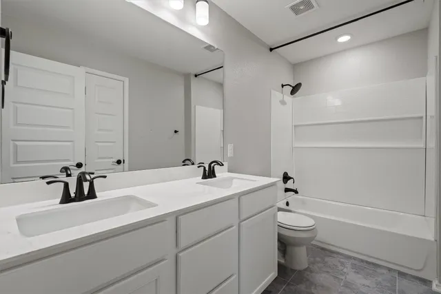 an empty room with chandelier fan