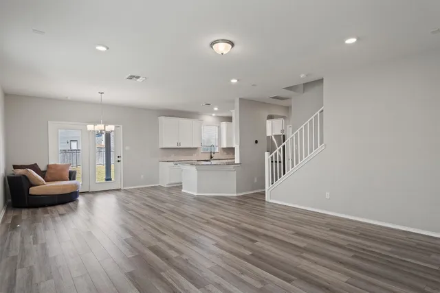 a view of kitchen with livingroom and hardwood floor