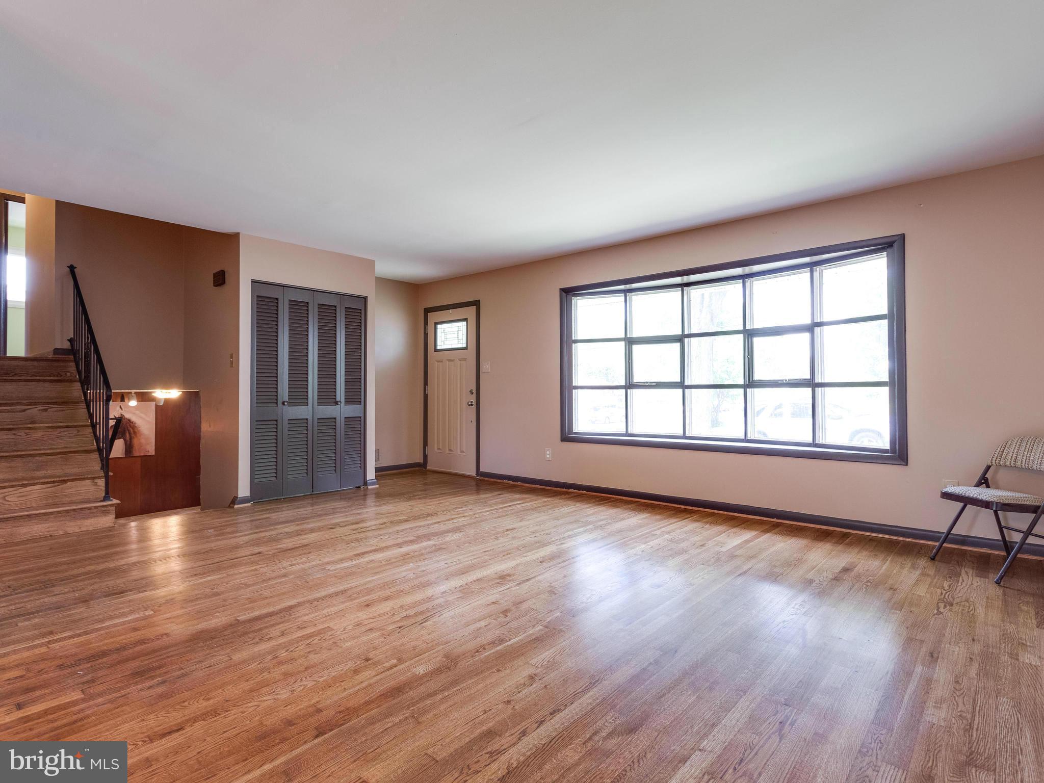 3908 Elby Street Silver Spring, MD 20906 - Photo 3 of 24 an empty room with wooden floor and windows