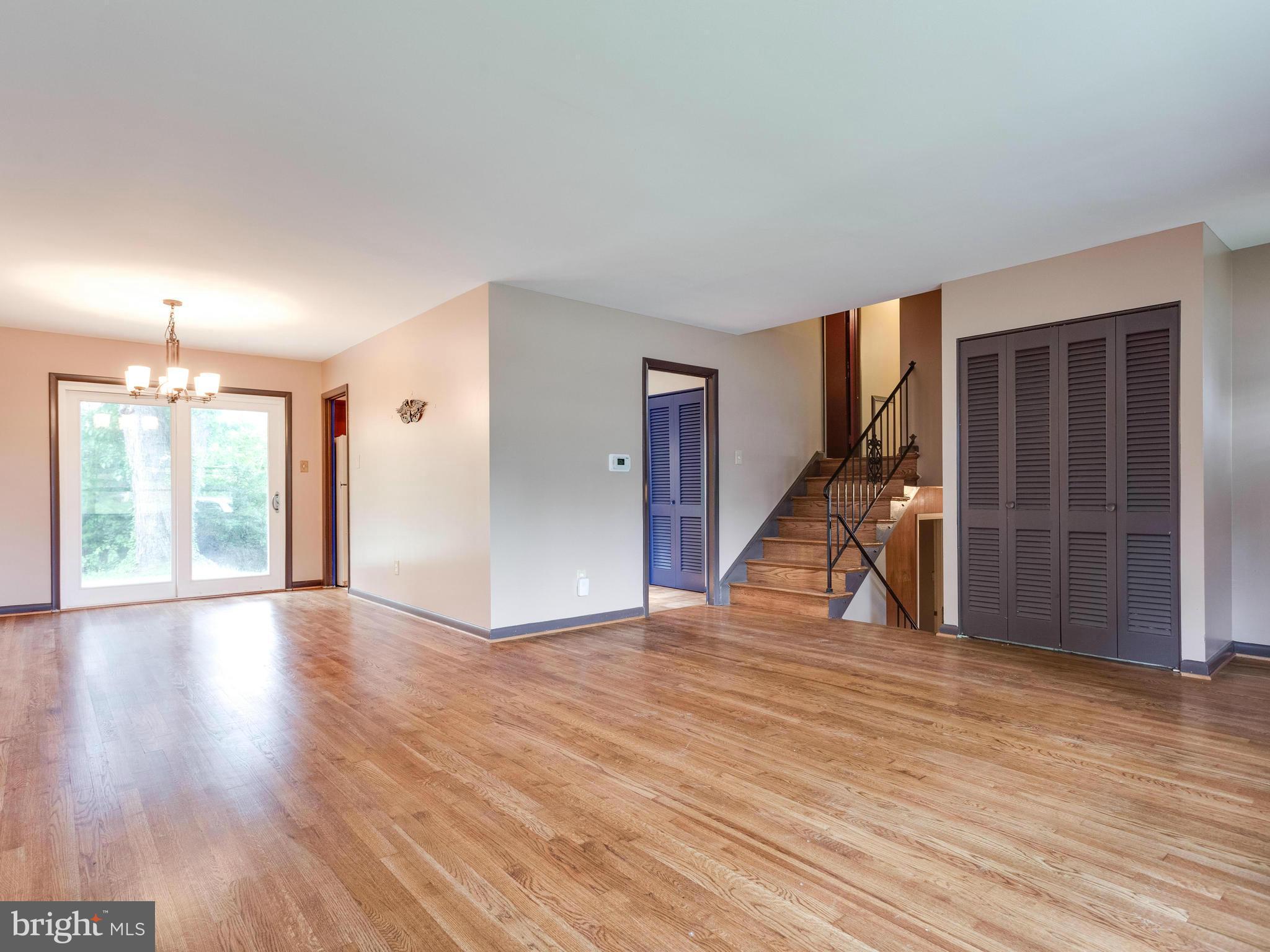 3908 Elby Street Silver Spring, MD 20906 - Photo 4 of 24 a view of an empty room with wooden floor and a window