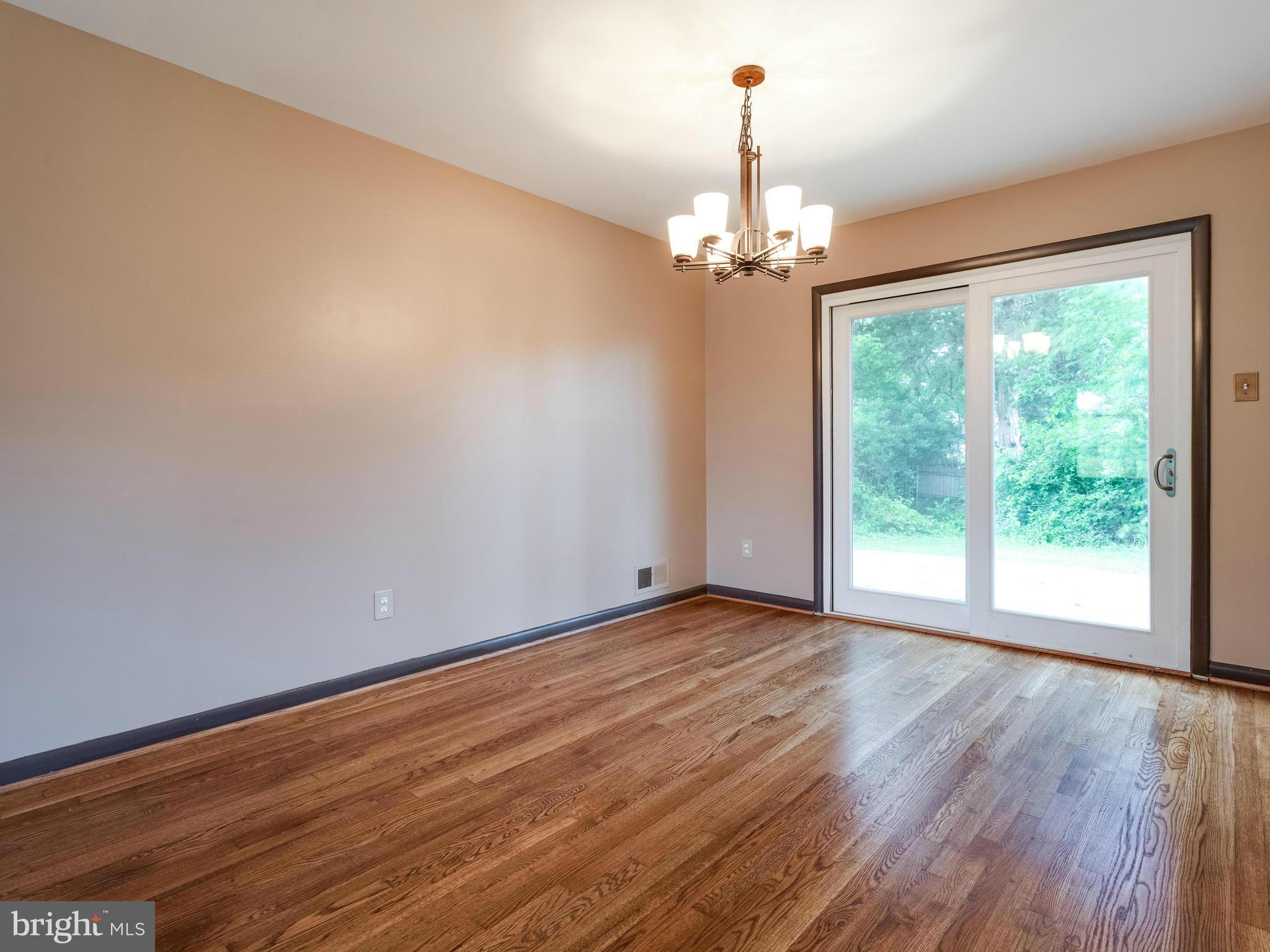 3908 Elby Street Silver Spring, MD 20906 - Photo 5 of 24 a view of livingroom with window ceiling fan and hardwood floor