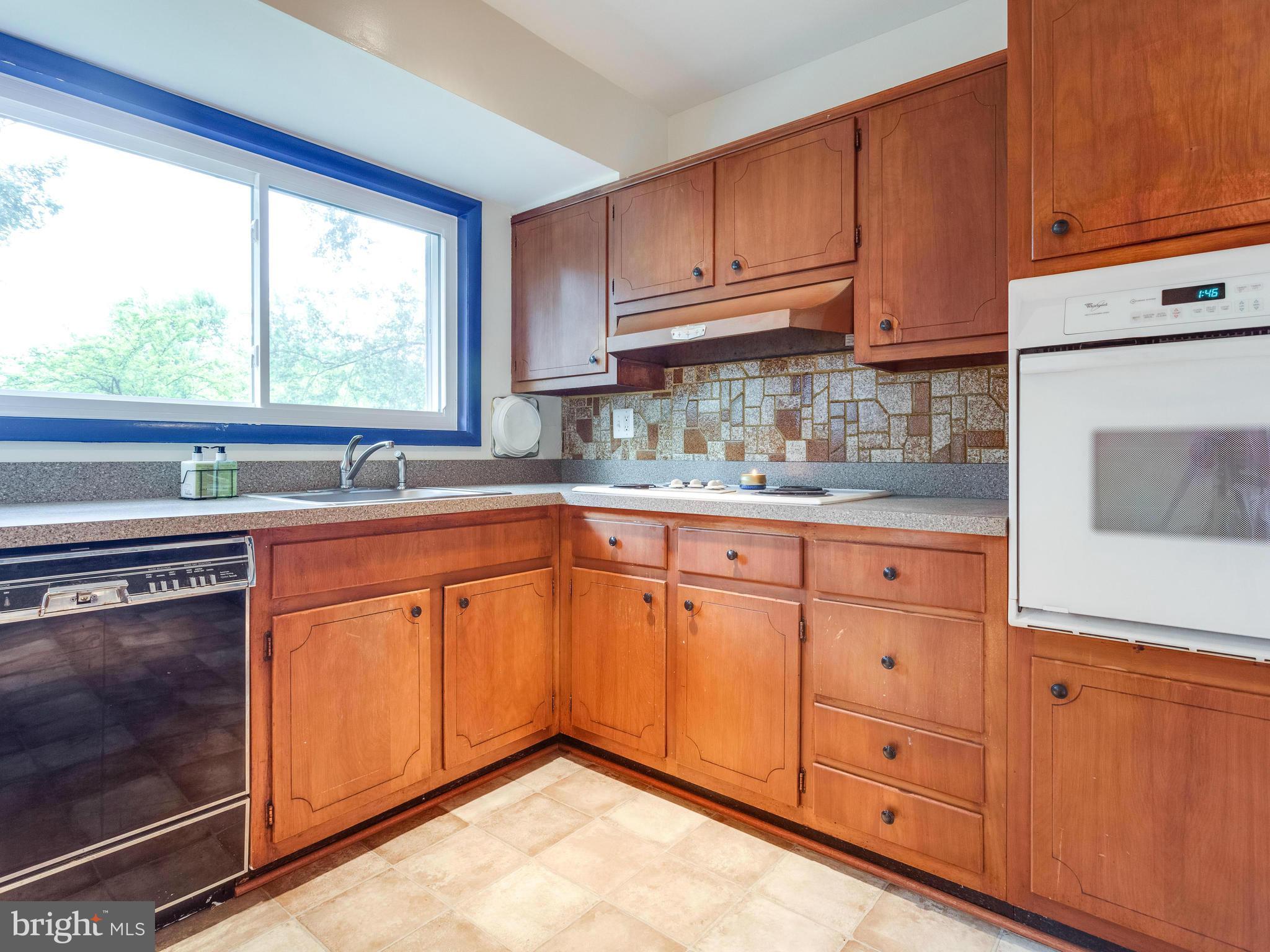 3908 Elby Street Silver Spring, MD 20906 - Photo 9 of 24 a kitchen with granite countertop cabinets stainless steel appliances a sink and window