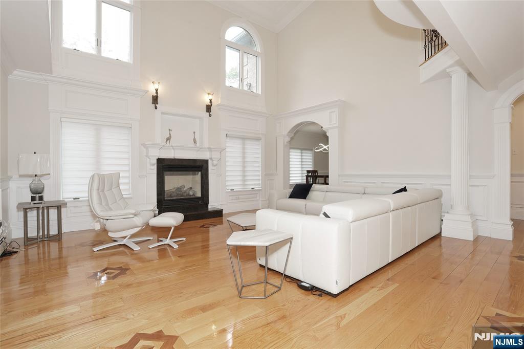 65 Ross Avenue Demarest, NJ 07627 - Photo 13 of 48 a living room with furniture a fireplace and wooden floor