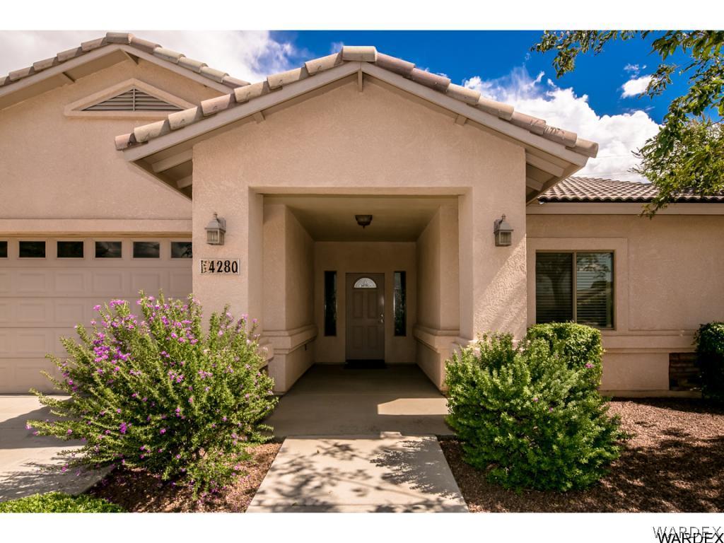 4280 East Cane Ranch Road Kingman, AZ 86401 - Photo 3 of 35 a view of a house with a flower garden