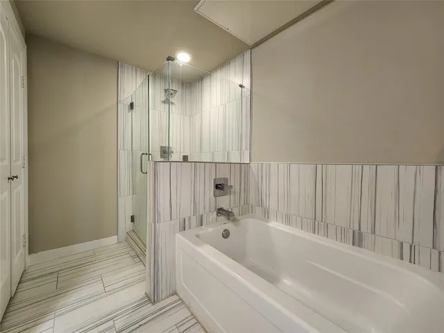 a bathroom with a bathtub and a shower