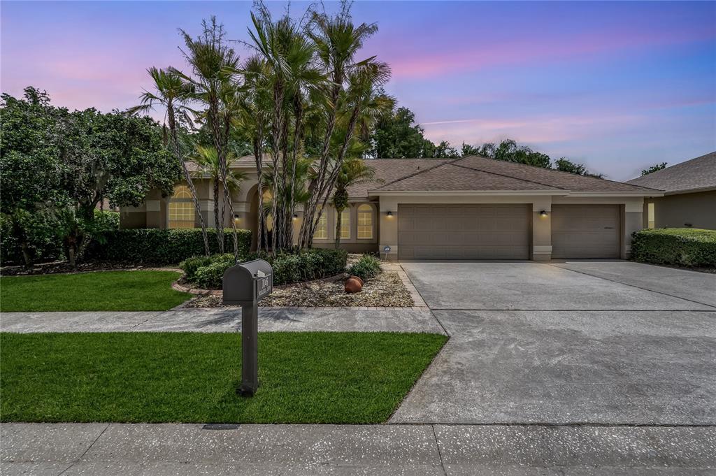 a front view of a house with a garden and yard