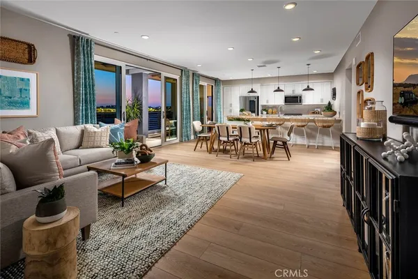 a living room with furniture and a dining table