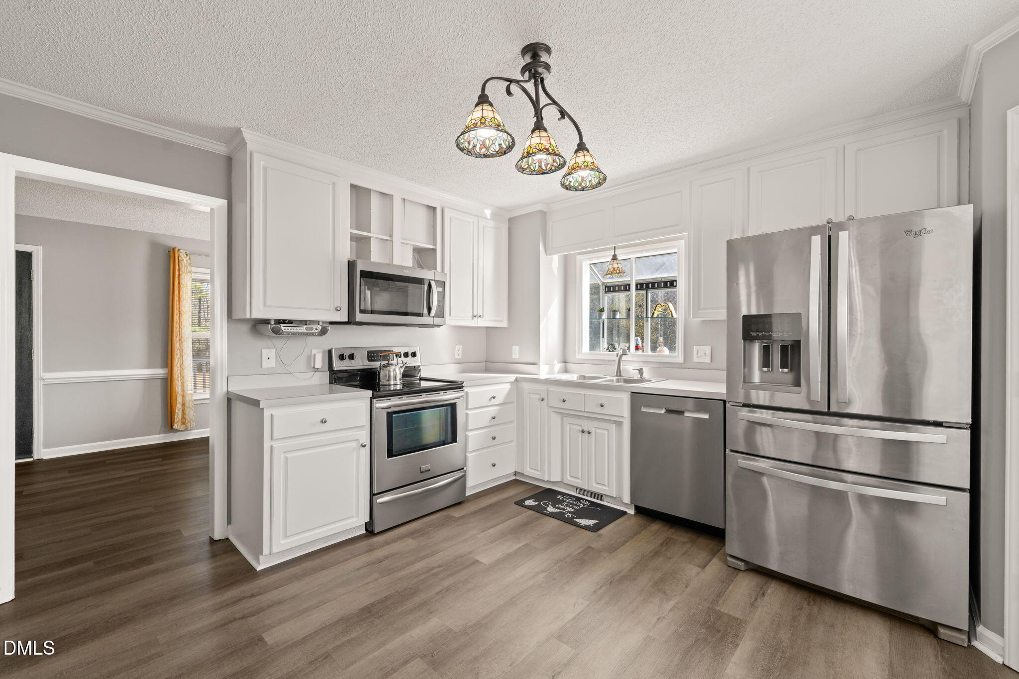 3649 Cleveland Road Smithfield, NC 27577 - Photo 11 of 37 a kitchen with granite countertop a refrigerator stove and wooden floor