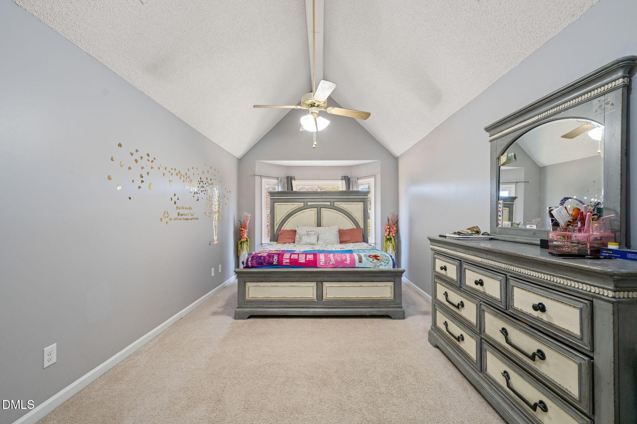 3649 Cleveland Road Smithfield, NC 27577 - Photo 18 of 37 a bedroom with a bed and a chandelier