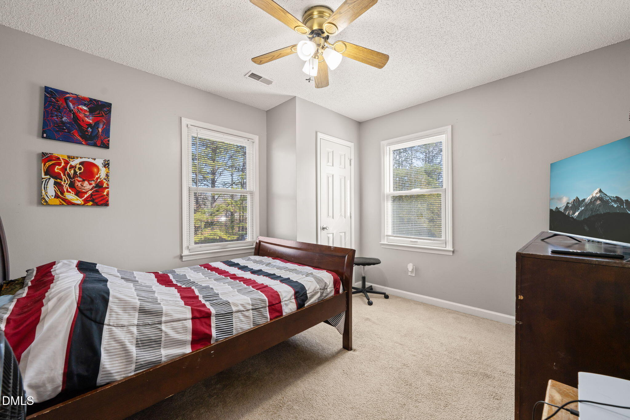 3649 Cleveland Road Smithfield, NC 27577 - Photo 26 of 37 a bedroom with a bed and a chandelier