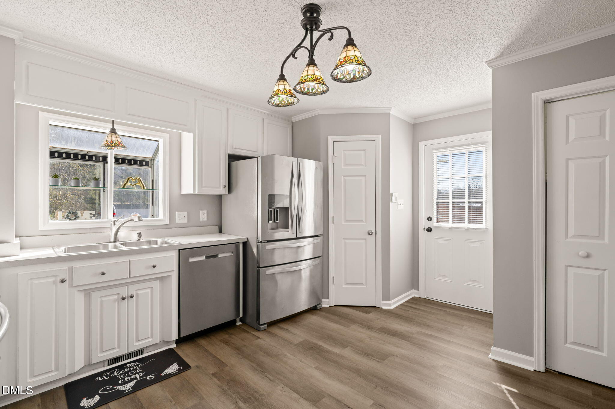 3649 Cleveland Road Smithfield, NC 27577 - Photo 9 of 37 a kitchen with stainless steel appliances granite countertop a sink a stove a refrigerator and dishwasher with wooden floor