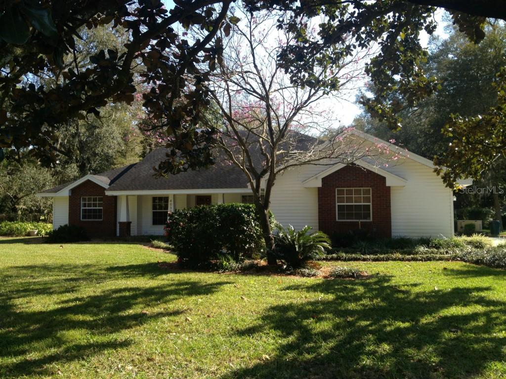 a front view of house with yard and trees