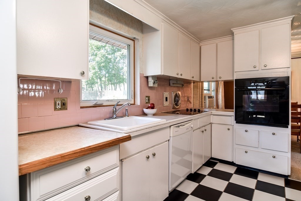 22 Francine Road Framingham, MA 01701 - Photo 11 of 30 a kitchen with granite countertop white cabinets white appliances and a sink