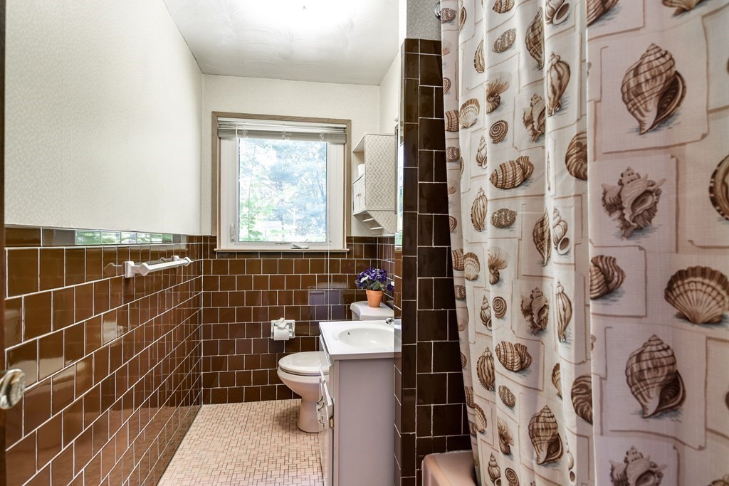 22 Francine Road Framingham, MA 01701 - Photo 14 of 30 a bathroom with a toilet and a shower curtain