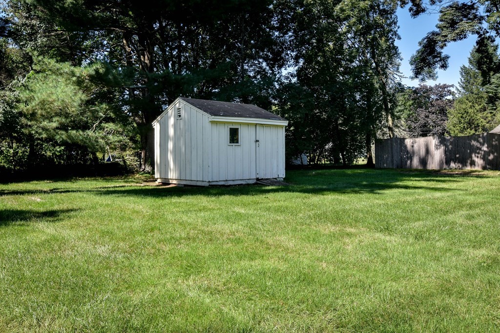 22 Francine Road Framingham, MA 01701 - Photo 24 of 30 a view of backyard with large trees and wooden fence