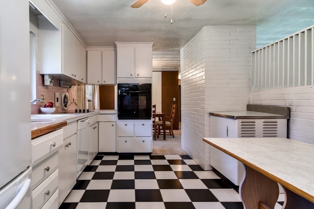 22 Francine Road Framingham, MA 01701 - Photo 10 of 30 a kitchen with stainless steel appliances a sink a stove a microwave and cabinets
