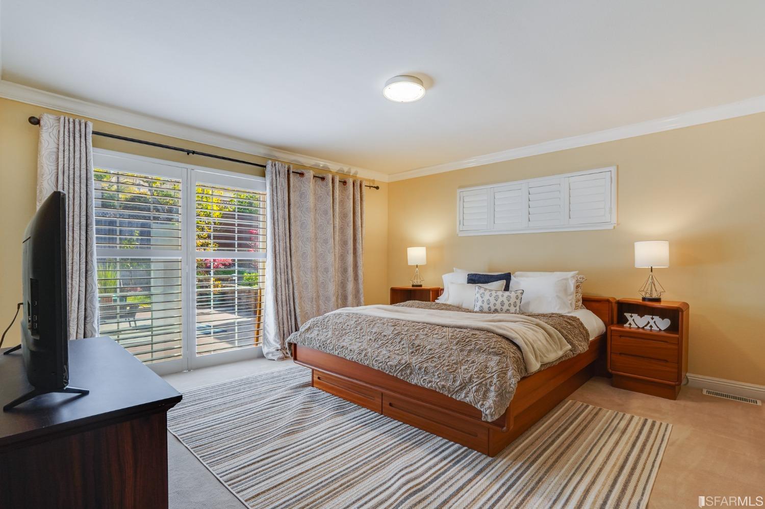 474 Oak Avenue San Bruno, CA 94066 - Photo 25 of 51 a bedroom with a large bed and a flat tv screen on dresser