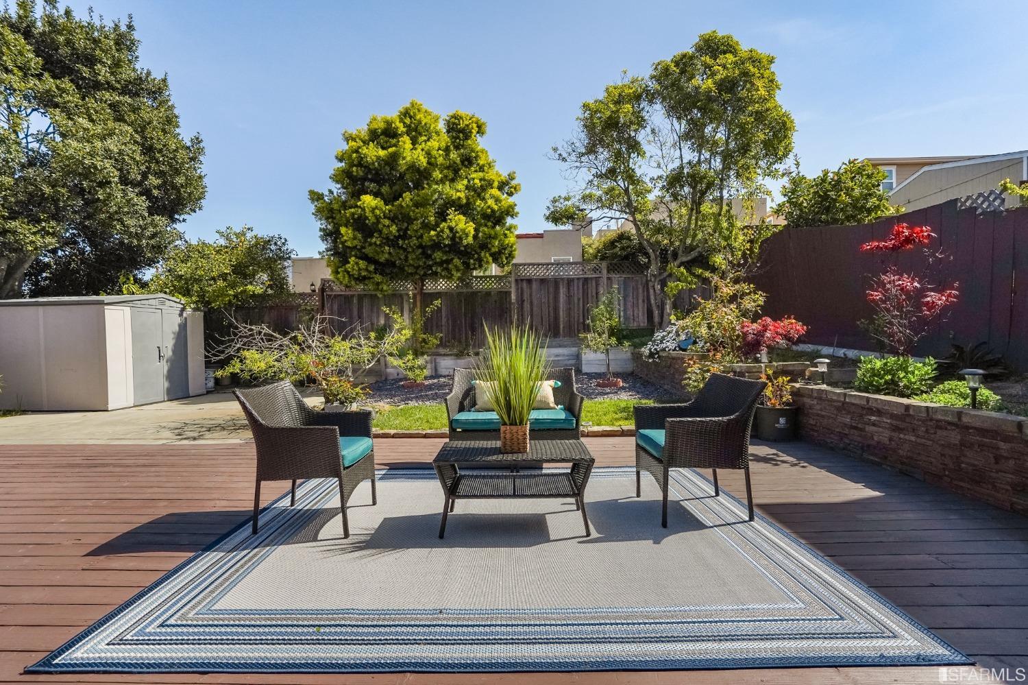 474 Oak Avenue San Bruno, CA 94066 - Photo 33 of 51 a view of a patio with table and chairs potted plants and a palm tree