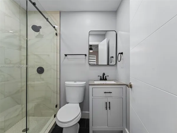 a bathroom with a toilet a sink and shower