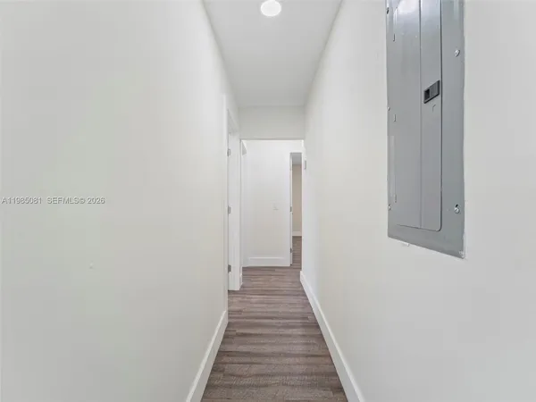 a view of a hallway with wooden floor