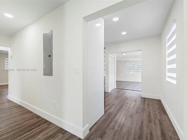 a view of hallway with wooden floor