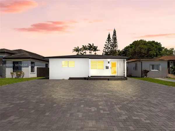a front view of a house with a yard and a garage