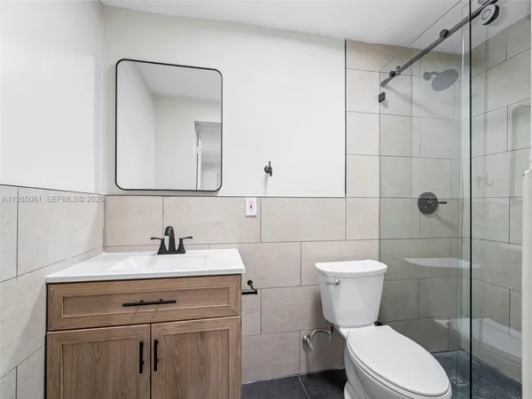 a bathroom with a toilet sink shower and mirror