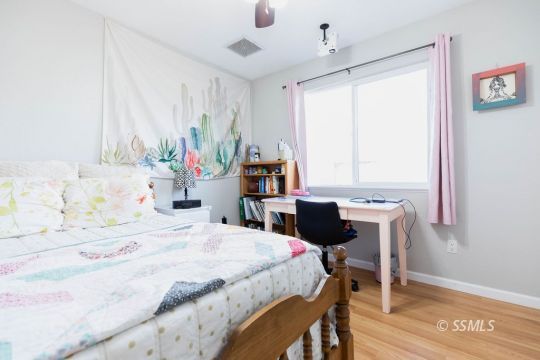632 South Gordon Street Ridgecrest, CA 93555 - Photo 20 of 30 a bedroom with a bed table chair and a window