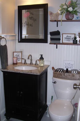 a bedroom with bed and wooden floor