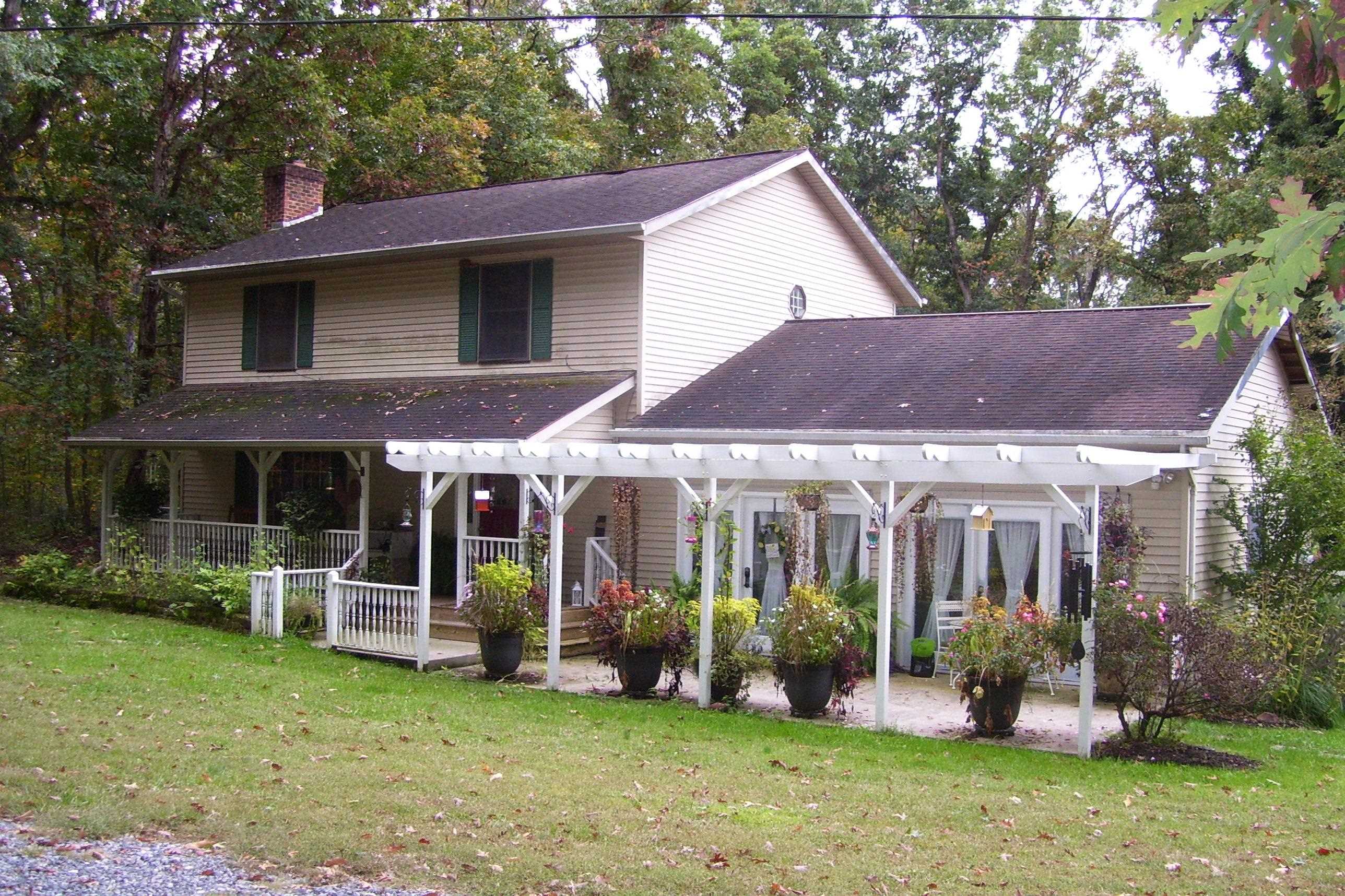 743 Comertown Road Shenandoah, VA 22849 - Photo 2 of 28 a view of a house with a yard and plants
