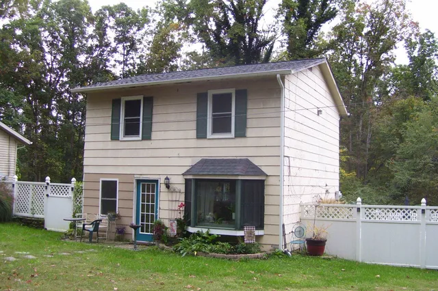 a front view of a house with a garden