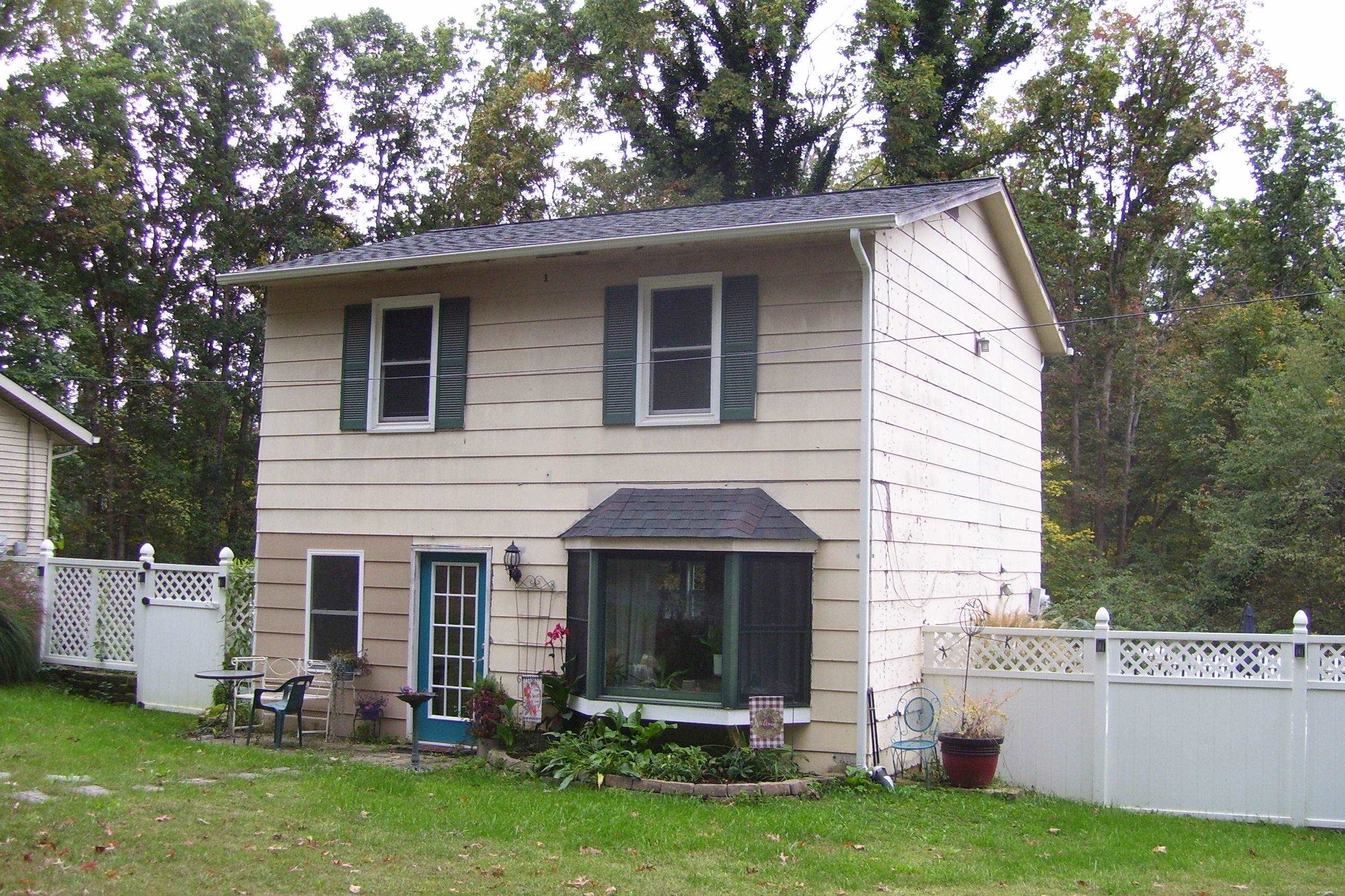 743 Comertown Road Shenandoah, VA 22849 - Photo 7 of 28 a view of a house with a yard and a large tree
