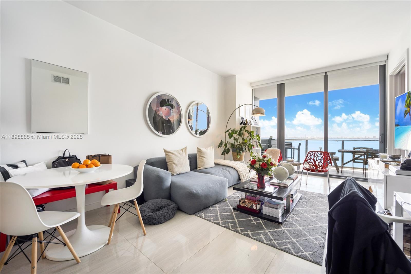 480 Northeast 31st Street, Unit 1602 Miami, FL 33137 - Photo 2 of 12 a living room with furniture and a large window