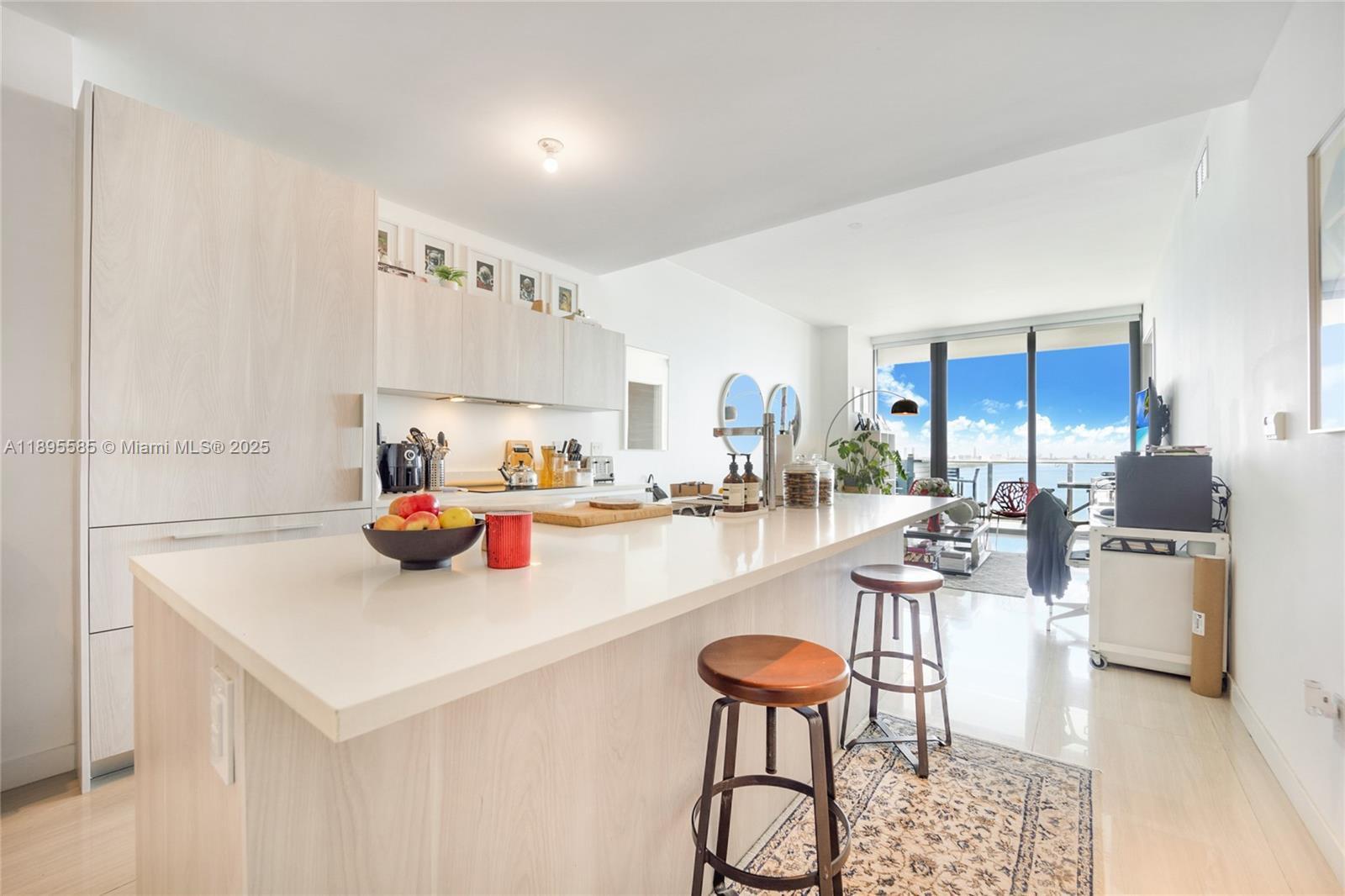 480 Northeast 31st Street, Unit 1602 Miami, FL 33137 - Photo 3 of 12 a kitchen with a dining table and chairs