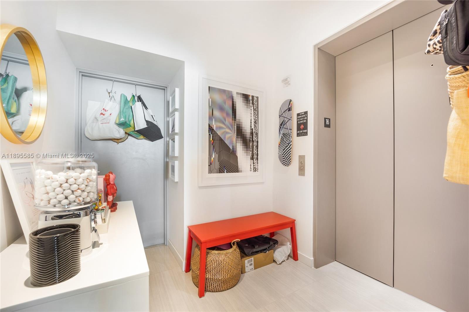 480 Northeast 31st Street, Unit 1602 Miami, FL 33137 - Photo 10 of 12 a living room with furniture and a mirror