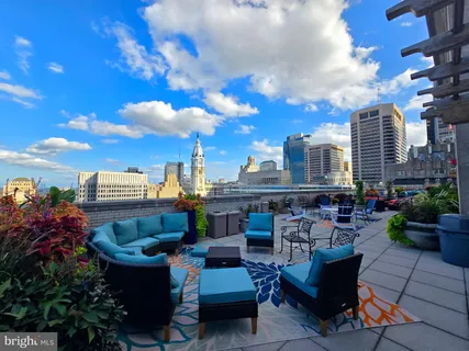 a view of city from balcony seating area and barbeque oven