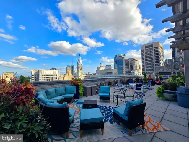 a view of city from balcony seating area and barbeque oven