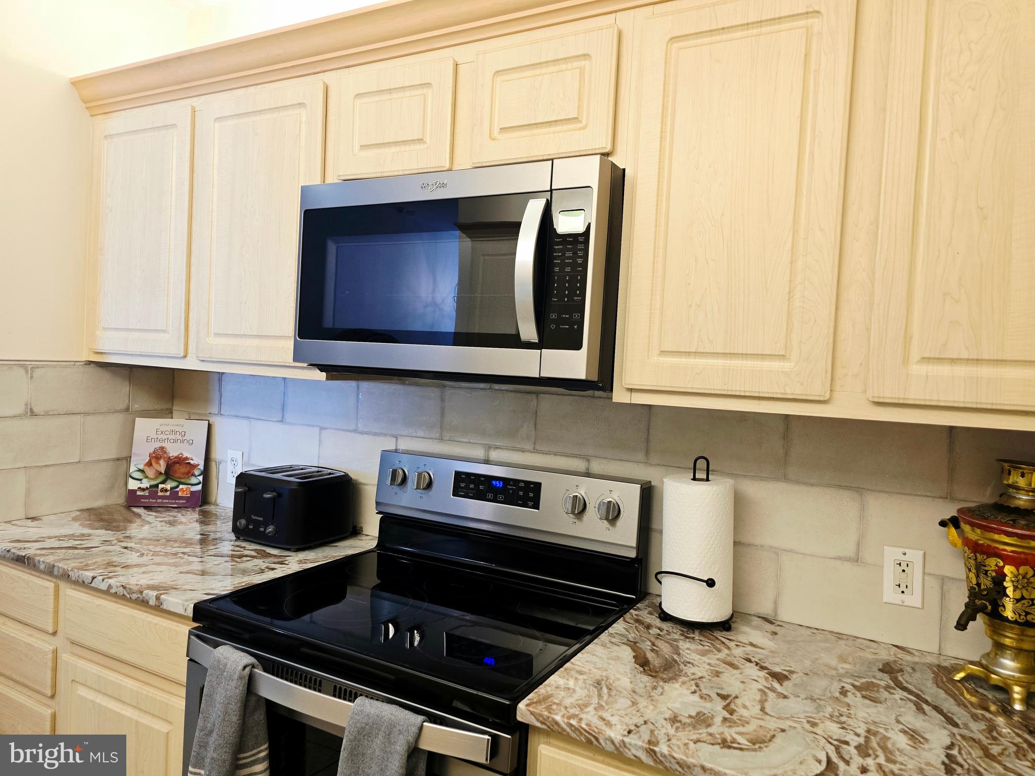 1600 Arch Street, Unit 1905 Philadelphia, PA 19103 - Photo 39 of 92 a kitchen with stainless steel appliances granite countertop a stove a microwave and cabinets