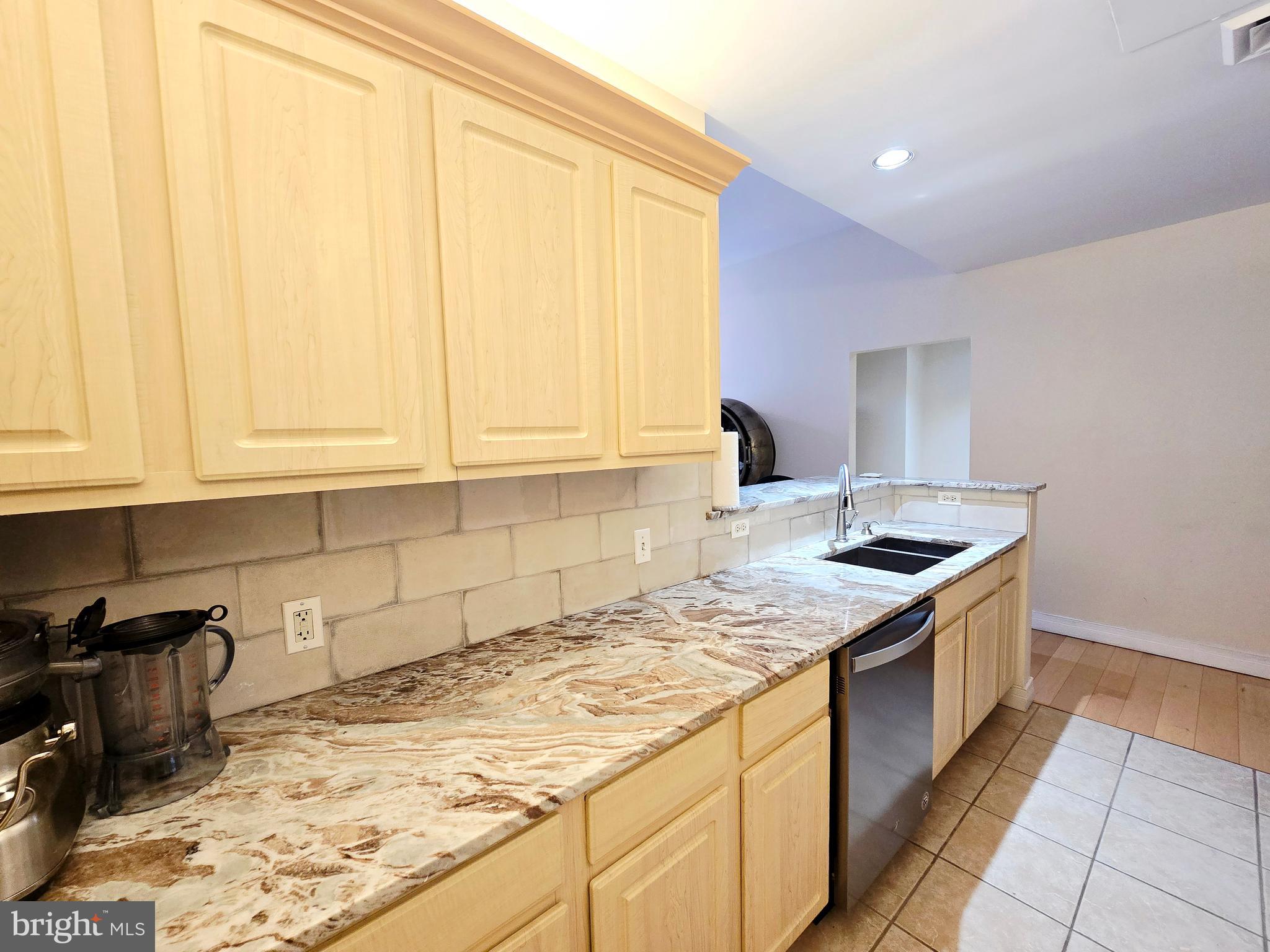 1600 Arch Street, Unit 1905 Philadelphia, PA 19103 - Photo 44 of 92 a kitchen with granite countertop sink and cabinets