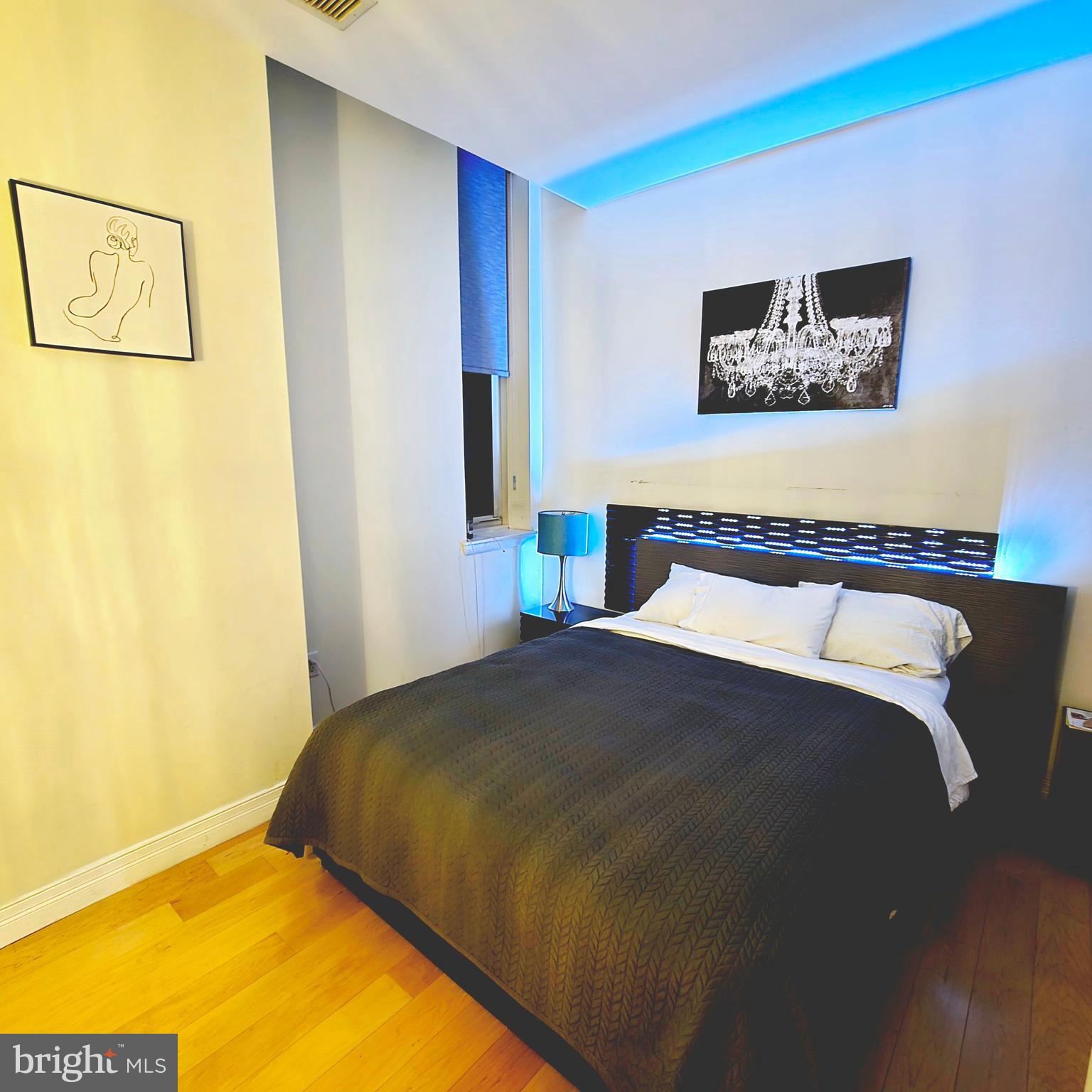 1600 Arch Street, Unit 1905 Philadelphia, PA 19103 - Photo 48 of 92 a bedroom with a bed and painting on the wall