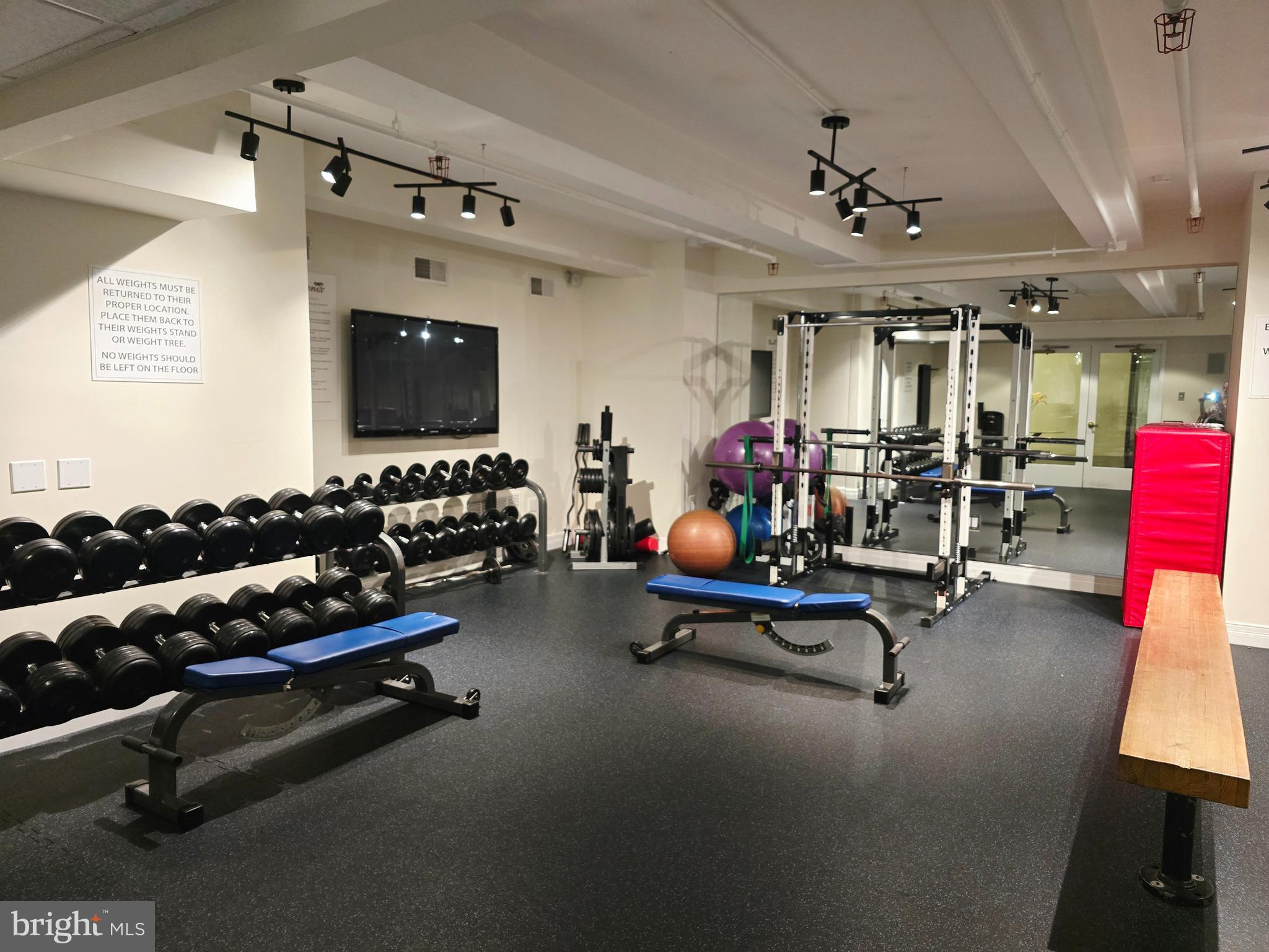 1600 Arch Street, Unit 1905 Philadelphia, PA 19103 - Photo 68 of 92 a room with gym equipment and a flat screen tv