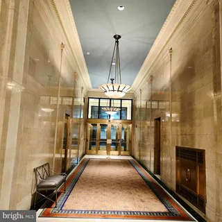 a living room with furniture and view of kitchen