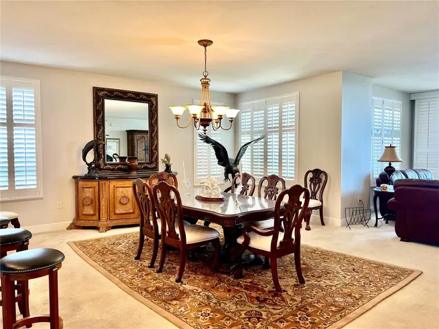 a view of a hallway with furniture and floor to ceiling window