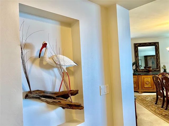 a living room with furniture a rug and a book shelf