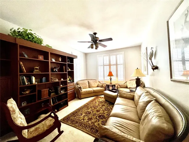 a living room with a bed furniture and a flat screen tv