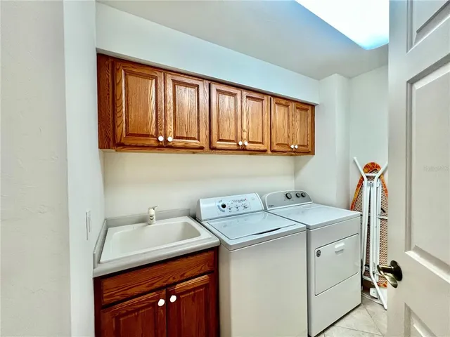 a bedroom with double bed and a chandelier