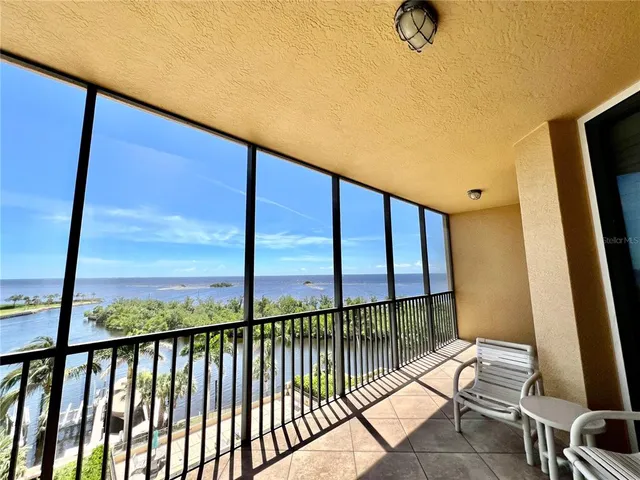 a living room with furniture a rug and a chandelier