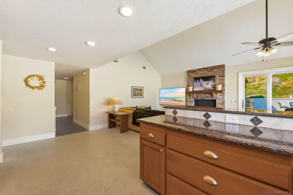 a living room with furniture and kitchen view