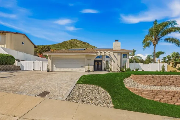 a front view of a house with a garden
